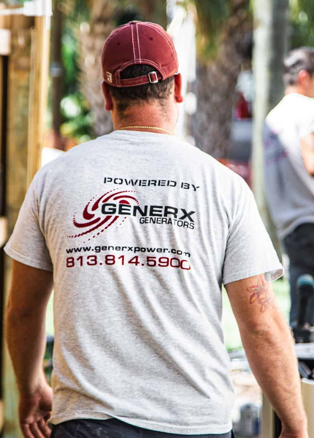GenerX technician on a job site, in a GenerX Generators work shirt